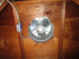 attic fan installed on roof with thermostat